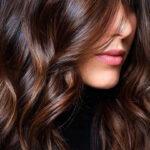Brunette hair styles with caramel balayage and layered waves.