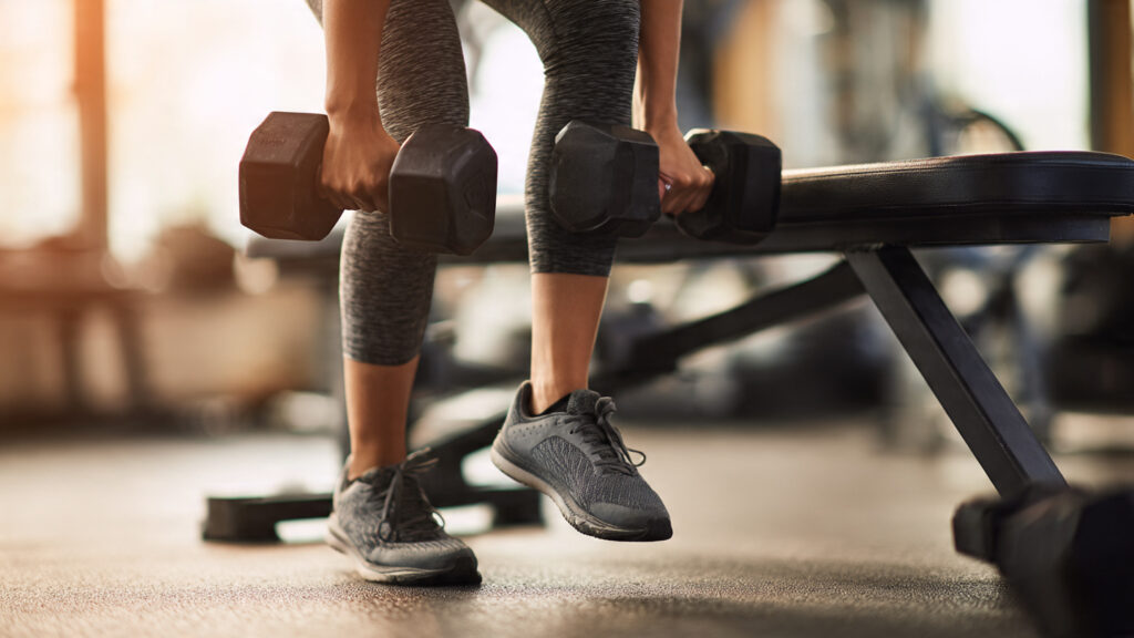 Weighted step-up exercise for glute and leg strength.