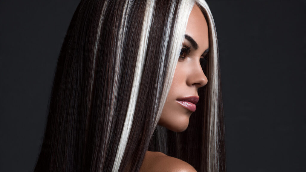 Brunette hair with platinum blonde highlights.