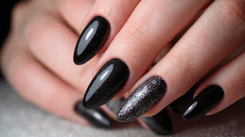 black nails with silver glitter accents