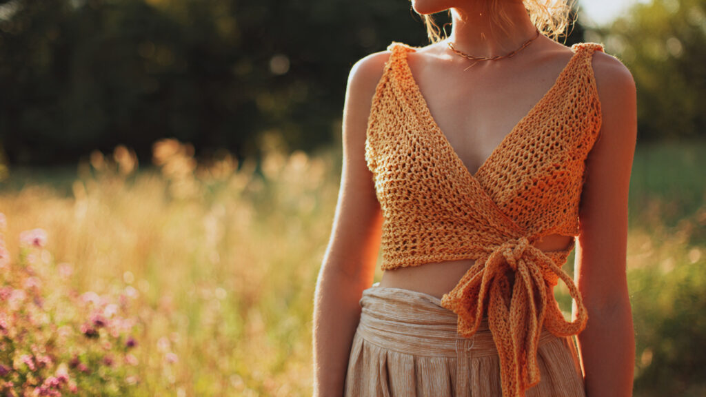 Crochet wrap top tied at waist for summer fashion.