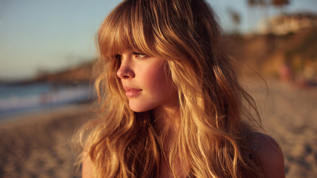 Wispy bangs paired with beach wave hairstyle.