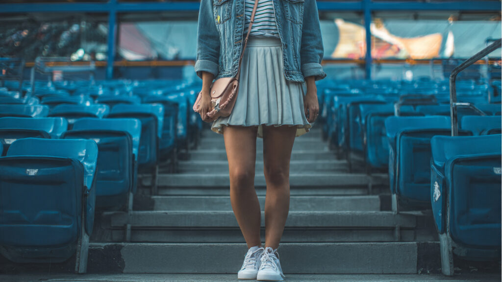 Denim jacket and mini skirt outfit for baseball game