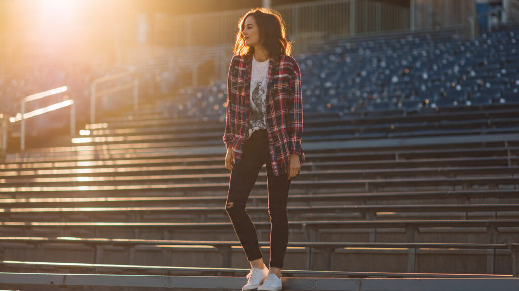 Plaid shirt layered over team tee for a stylish baseball game outfit