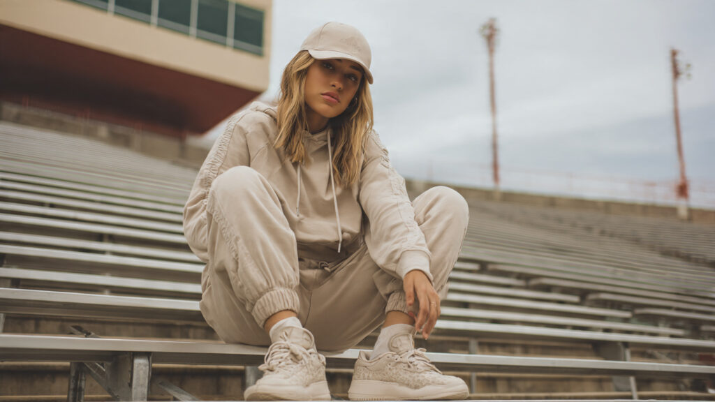 Neutral-colored tracksuit paired with sneakers for comfortable baseball game outfit