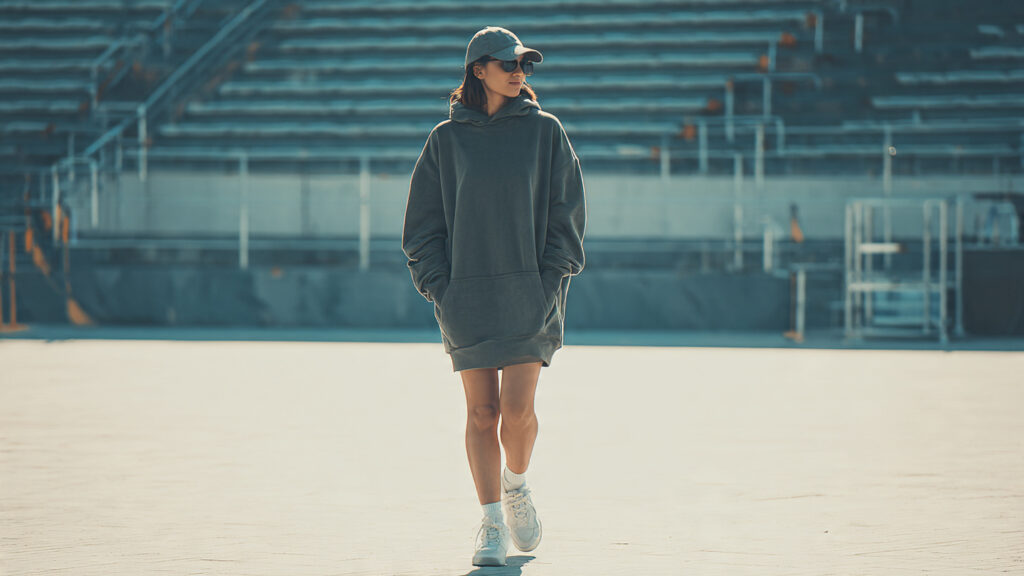 Hoodie dress and sneakers styled for a comfortable baseball game outfit