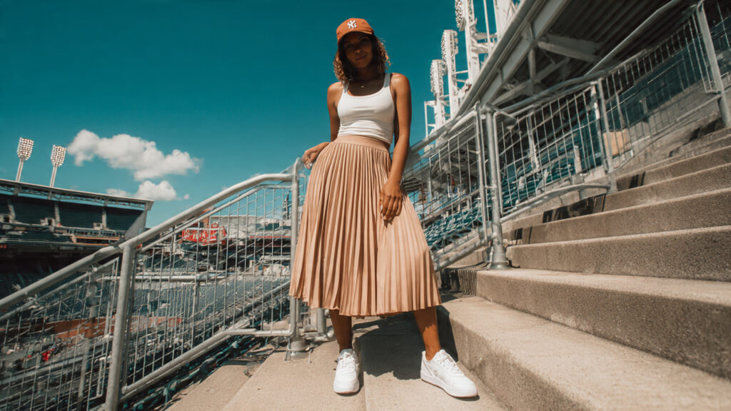 Midi skirt paired with team tank top for baseball game outfit