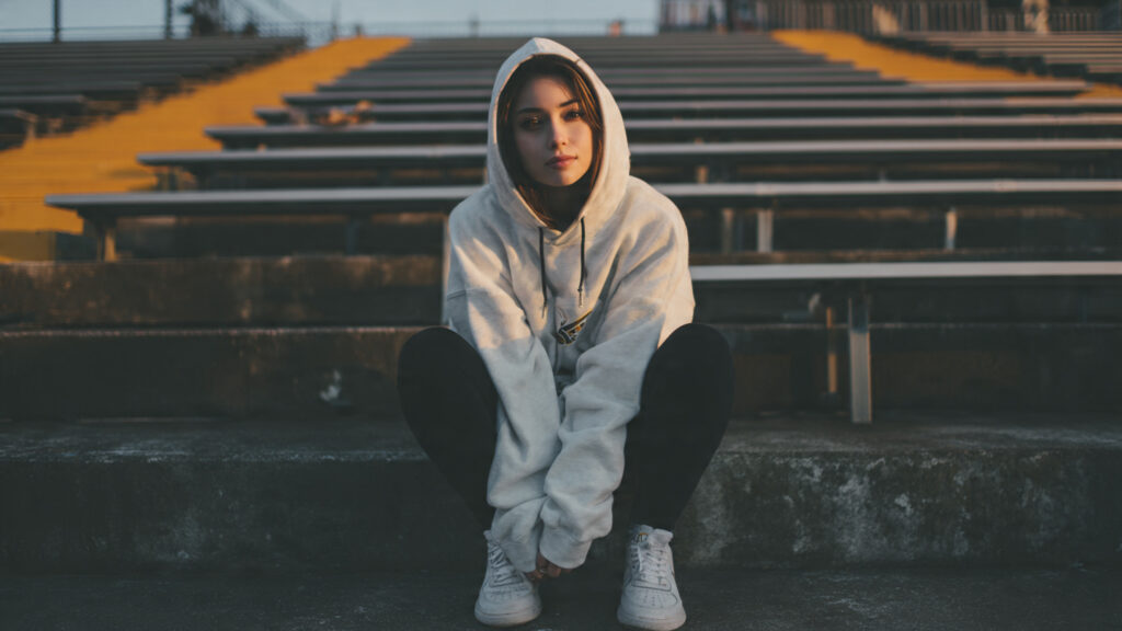Oversized team hoodie paired with leggings for a baseball game